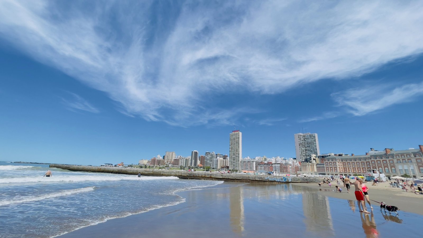 a beach with buildings in the background